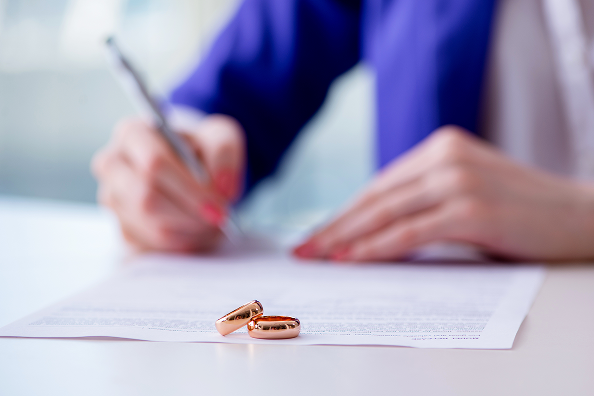 Woman signing prenuptial agreement